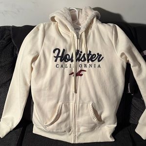 Hollister white hoodie with blue and red letters size medium fur on the inside